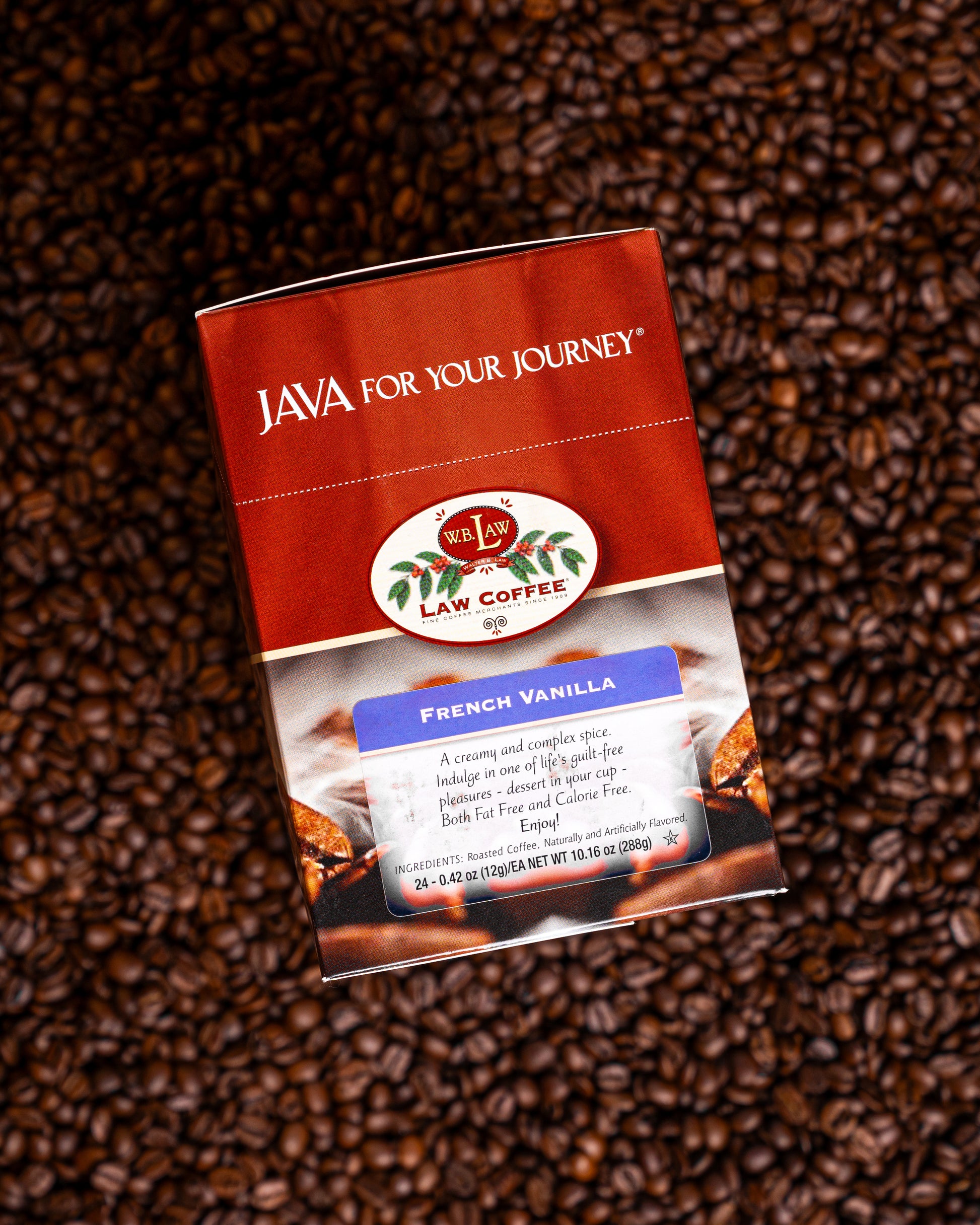 A box of Law Coffee French Vanilla single serve coffee on a bed of coffee beans