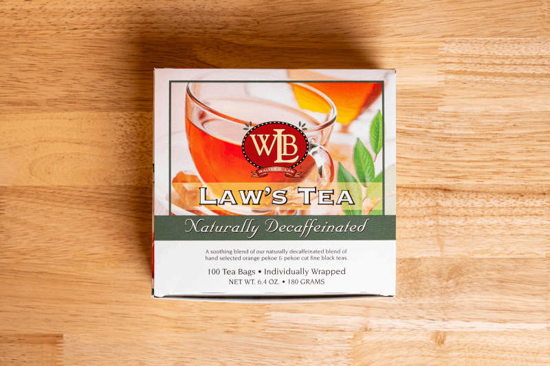 a white box of Law's decaf tea sitting on a wood table. 