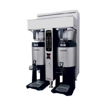 A dual fetco coffee brewer and luxus coffee dispensers. 