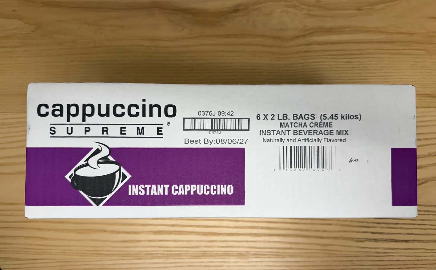 Box of Matcha Creme instant cappuccino on a wooden surface