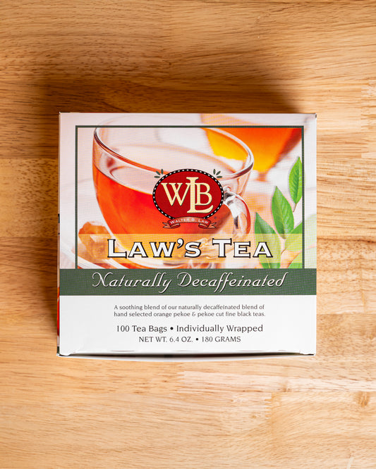 A box of Law's Naturally Decaffeinated Tea with individually wrapped sachets with a picture of a cup of tea and orange pekoe on the front.