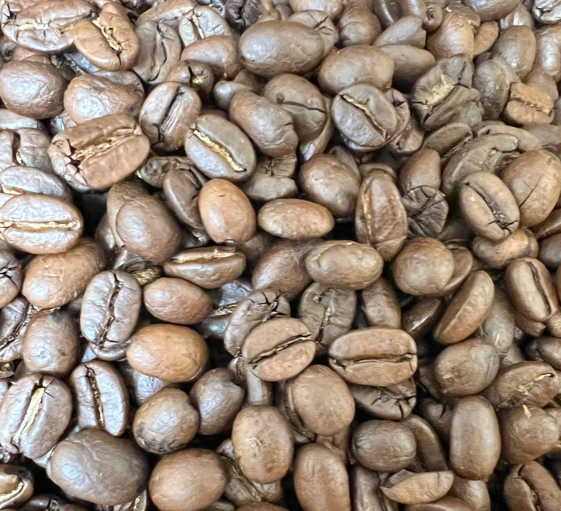 a pile of roasted colombian coffee beans