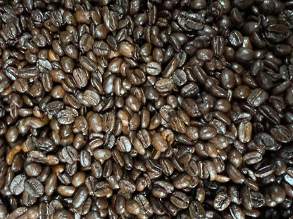 a pile of shiny dark roasted espresso beans. 